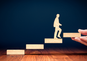 Man walking up wooden blocks
