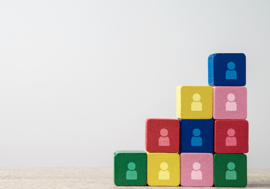 Colorful blocks with cartoon people on them symbolizing using enneagram for hiring a team