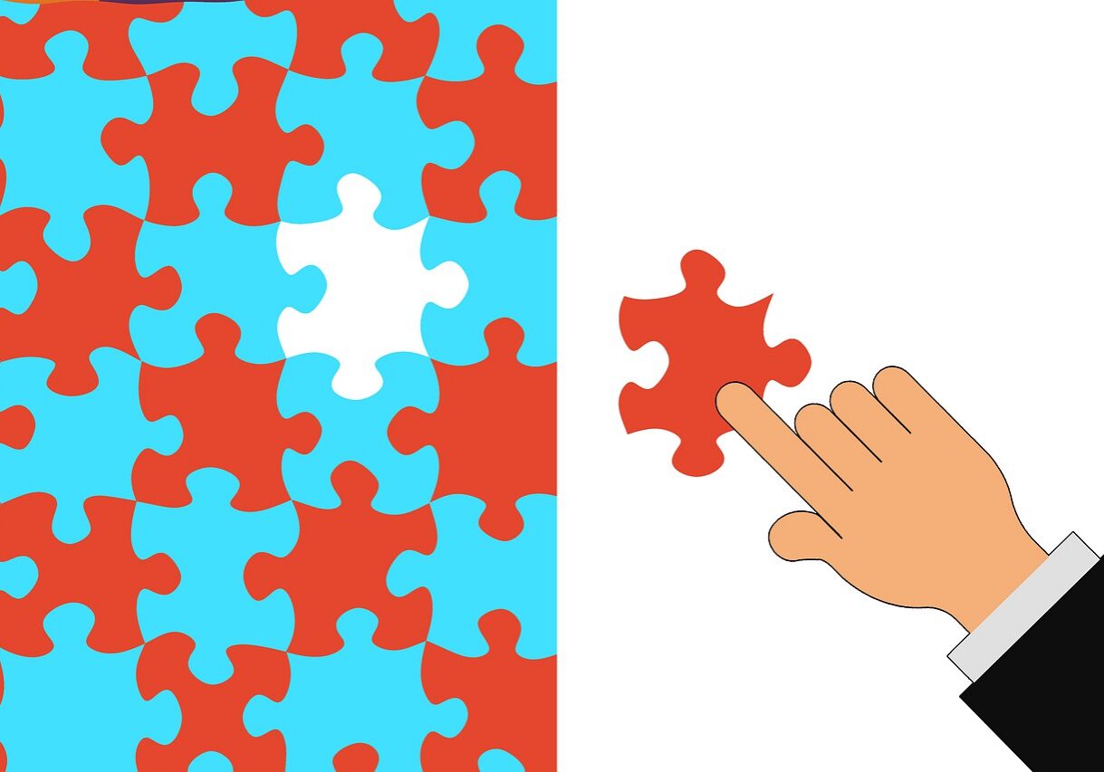 A hand places the last piece into a puzzle