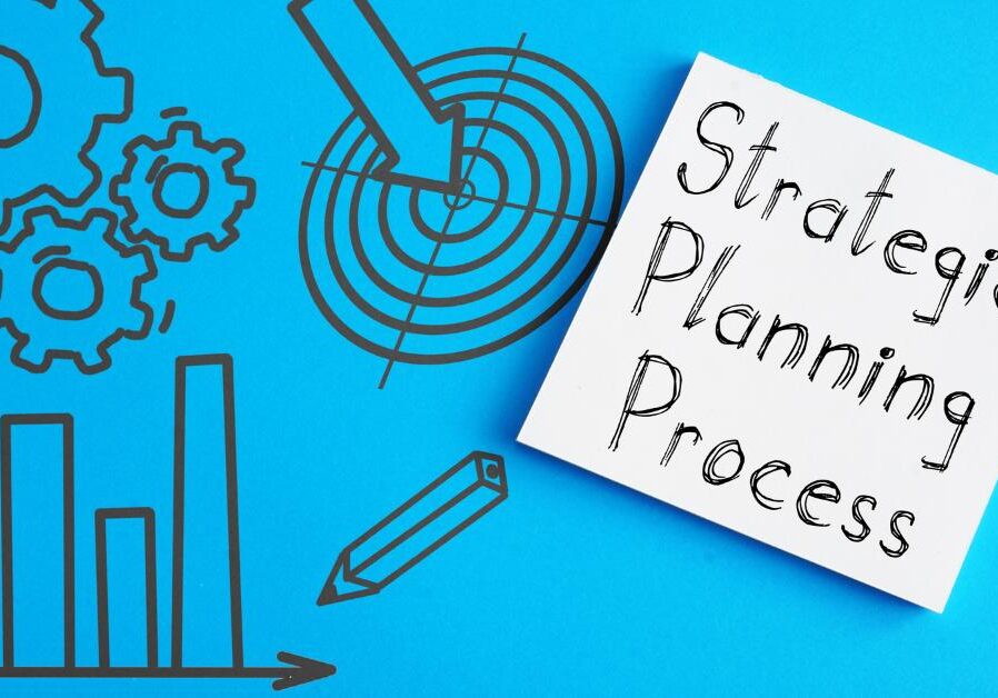 graphic of a chart, gears, target, and pencil with a sticky note that says Strategic Planning Process