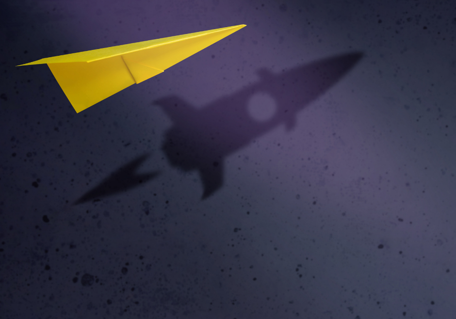 Yellow paper airplane in flight with rocket ship shadow